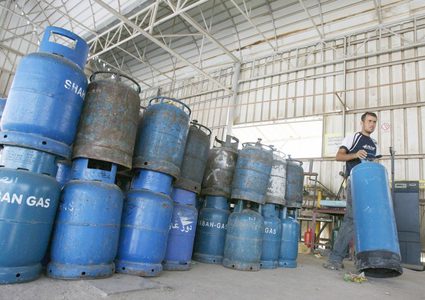 مواطنون يلجأون لتعبئة اسطوانات الغاز بالكيلو