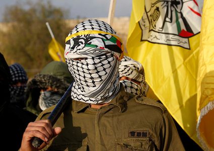 أعضاء فلسطينيون مقنعون في موكب حركة فتح خلال الاحتفال بالذكرى الرابعة والخمسين لتأسيس حركة فتح ، في قرية بني نعيم ، بالقرب من مدينة الخليل في الضفة الغربية ، 5 كانون الثاني / يناير ، 2019.