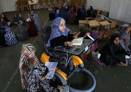 امرأة فلسطينية معاقة ، إيمان أبو سبحة ، 33 عاماً ، تقدم درساً في تحفيظ القرآن الكريم ، خلال عطلة صيفية في مسجد ، في خان يونس في جنوب قطاع غزة.
