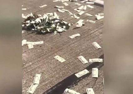 السماء "تمطر" دولارات حقيقية فوق شارع مزدحم! (فيديو)