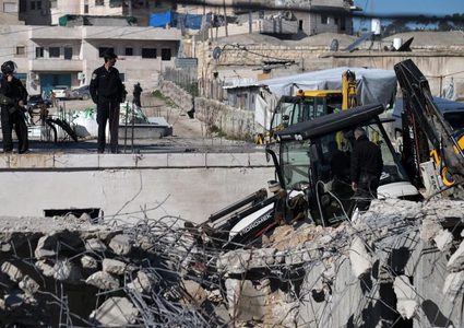 الاحتلال يهدم سورا في حزما ويخطر بهدم منشآت أخرى