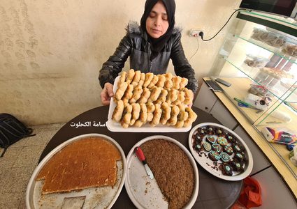 أم الغلابة.. سهير عليوة تعمل في صناعة المعجنات والحلويات وبيعها أمام تجمع مدارس وسط غزة لتعيل أسرتها