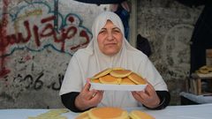 سيدة فلسطينية من غزة تصنع وتبيع القطايف في سوق محلية وسط القطاع