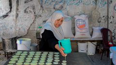 سيدة فلسطينية من غزة تصنع وتبيع القطايف في سوق محلية وسط القطاع