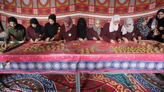 فلسطينيات يشاركن في تحضير الكعك لتوزيعه للمحتاجين، ضمن مبادرة خيرية