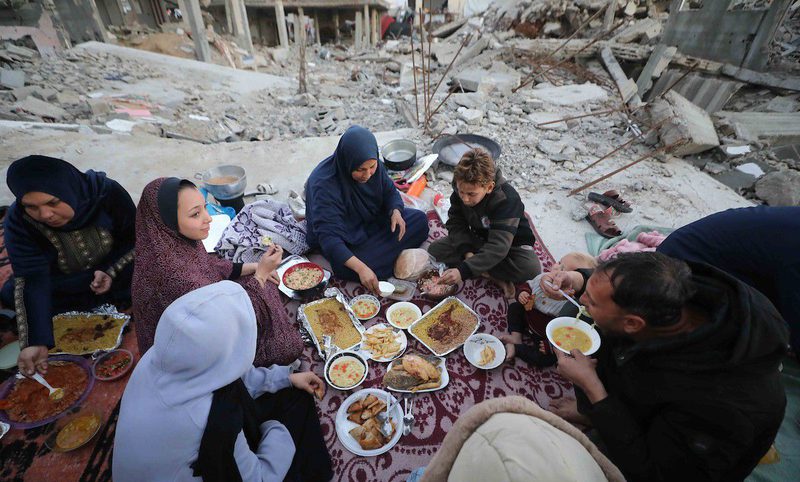 بالصور عائلة فلسطينية تتناول إفطارها خلال شهر رمضان على سطح منزلها الذي دمره قصف جوي إسرائيلي خلال حرب غزة